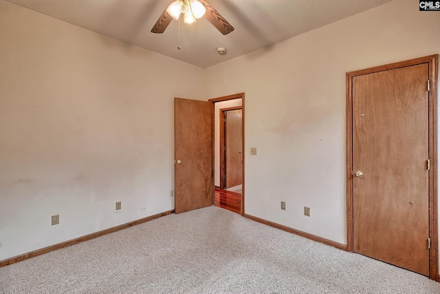 empty room featuring ceiling fan and light colored carpet