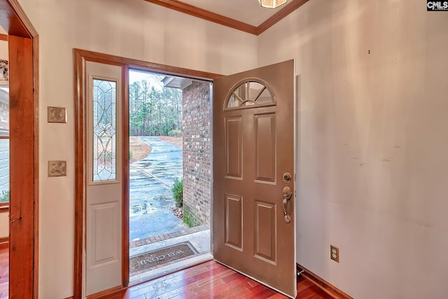 entryway featuring hardwood / wood-style flooring and ornamental molding