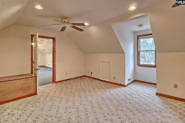 additional living space featuring lofted ceiling, carpet flooring, and ceiling fan