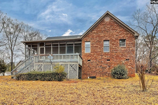 rear view of house featuring a sunroom