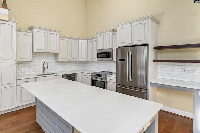 kitchen with dark hardwood / wood-style flooring, sink, white cabinets, and appliances with stainless steel finishes