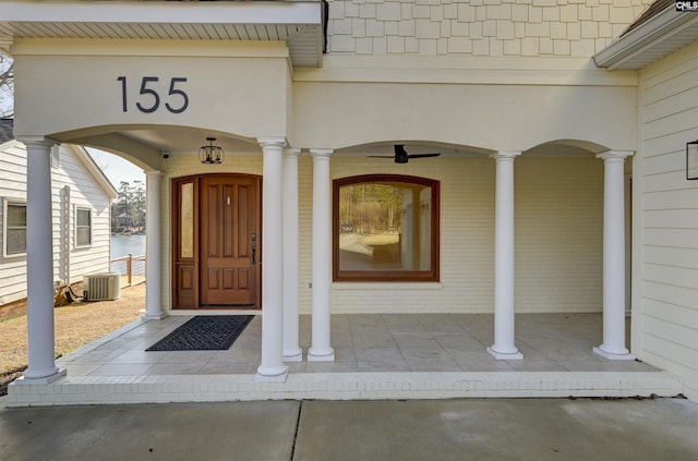 doorway to property with covered porch and central air condition unit