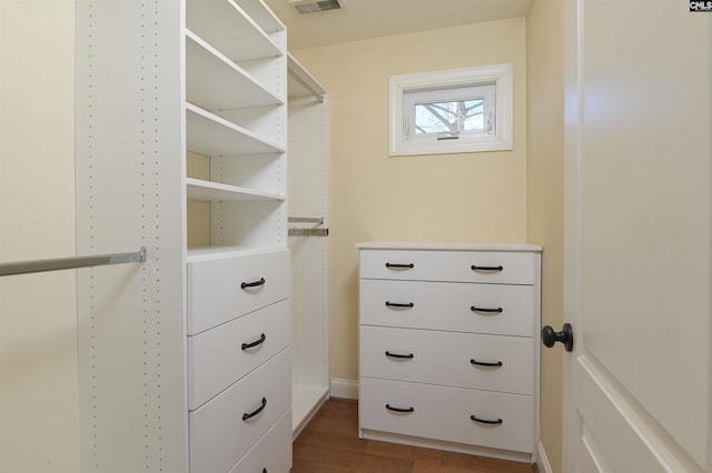 walk in closet with hardwood / wood-style flooring