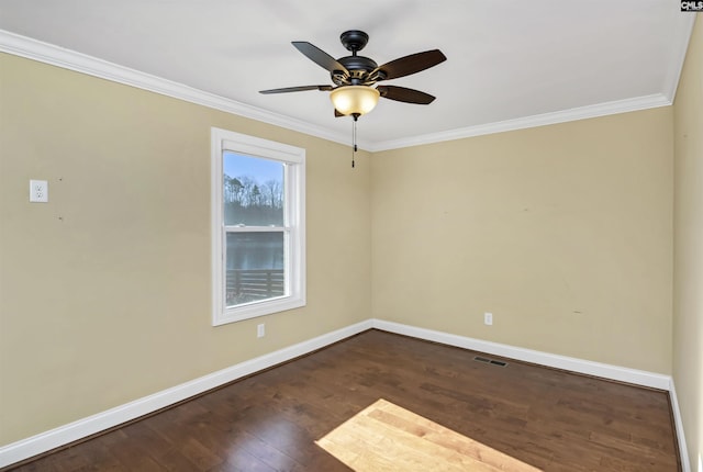 spare room featuring crown molding, dark wood-type flooring, and ceiling fan