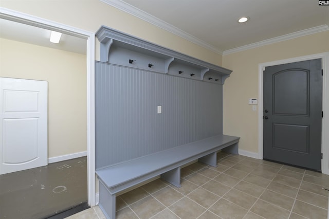 mudroom with crown molding and light tile patterned floors