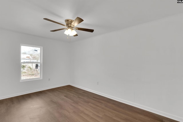 empty room with ceiling fan and dark hardwood / wood-style flooring