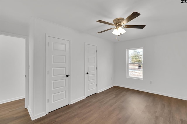 unfurnished bedroom featuring dark hardwood / wood-style flooring and ceiling fan