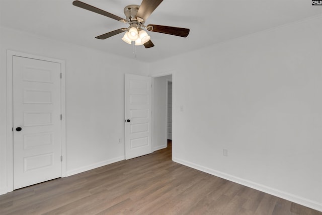 unfurnished room featuring crown molding, hardwood / wood-style flooring, and ceiling fan