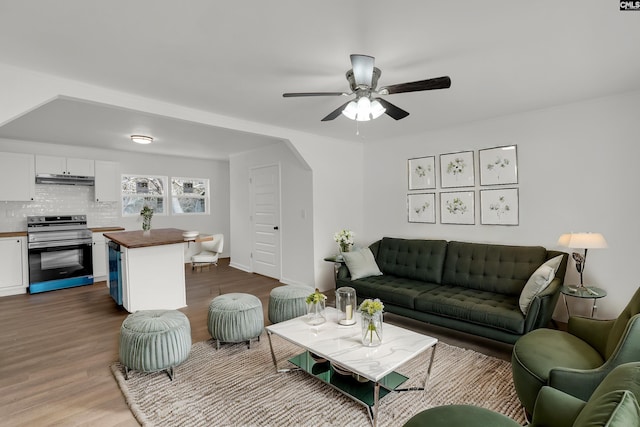 living room with hardwood / wood-style flooring and ceiling fan