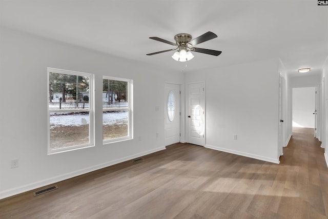 interior space with ceiling fan and light hardwood / wood-style floors