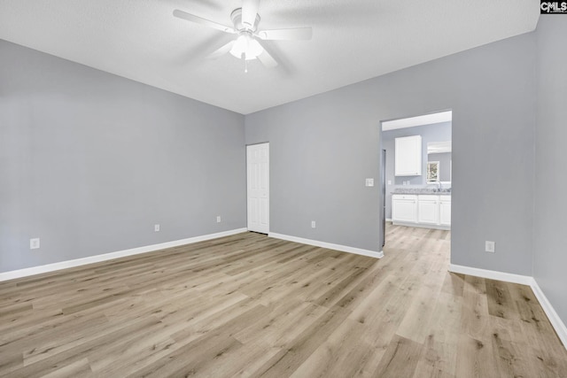 spare room with ceiling fan and light hardwood / wood-style floors