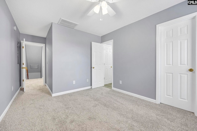 unfurnished bedroom featuring light carpet and ceiling fan