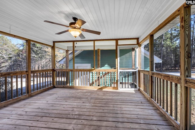 unfurnished sunroom featuring ceiling fan