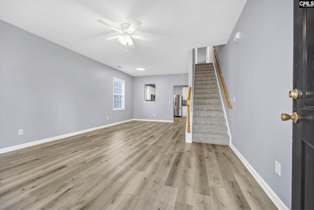 interior space with ceiling fan and light wood-type flooring