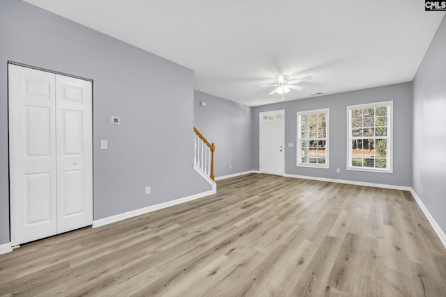 unfurnished living room featuring ceiling fan and light hardwood / wood-style floors