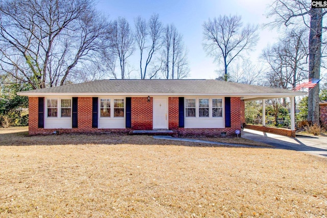 ranch-style home with a carport and a front lawn