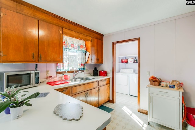 kitchen with washer and clothes dryer and sink