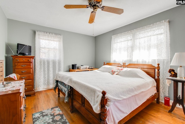 bedroom with wood-type flooring and ceiling fan