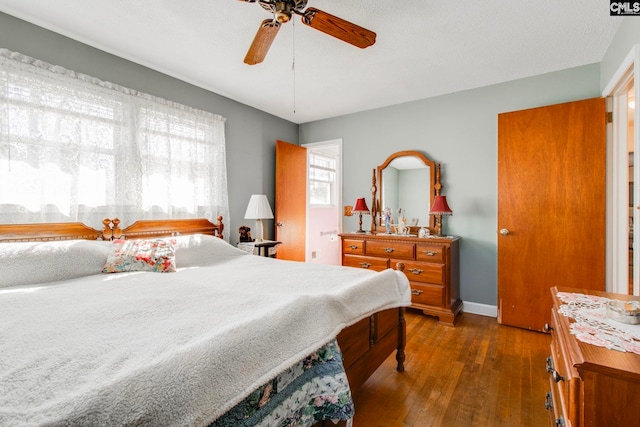 bedroom with ceiling fan and dark hardwood / wood-style flooring