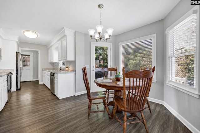 dining space with dark wood-type flooring, sink, and a notable chandelier