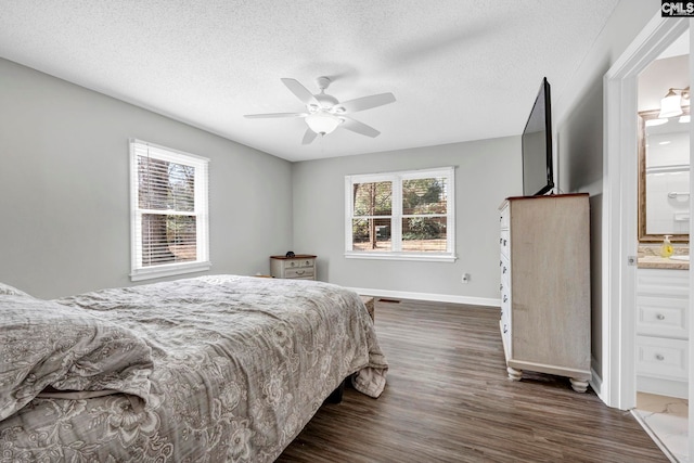 bedroom with connected bathroom, dark hardwood / wood-style floors, a textured ceiling, and ceiling fan