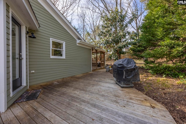 wooden terrace featuring grilling area