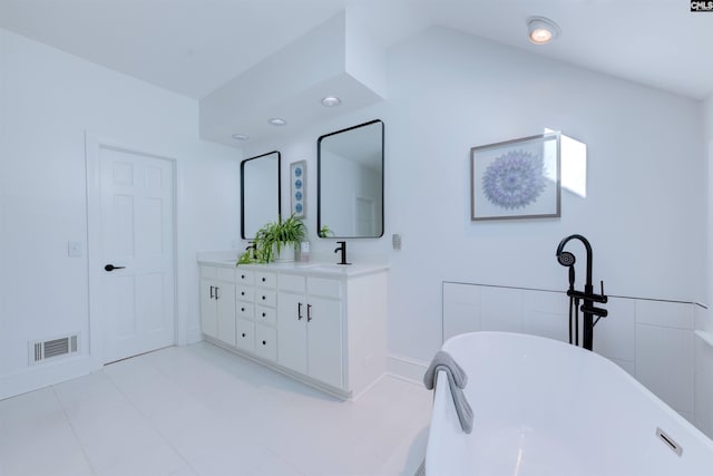 bathroom with vanity and a bathtub