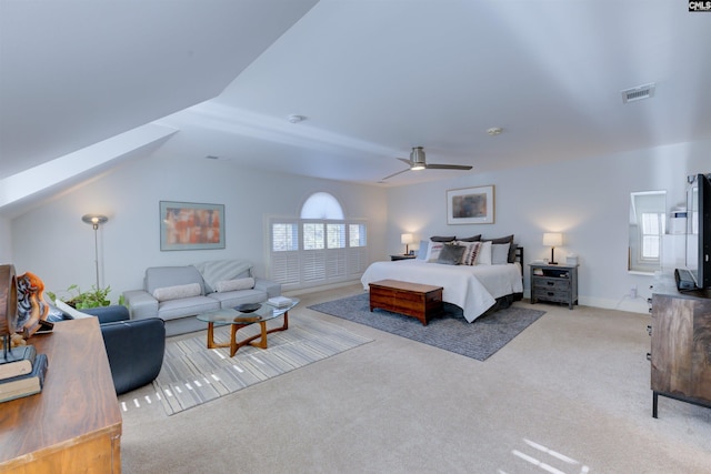 carpeted bedroom with multiple windows, vaulted ceiling, and ceiling fan