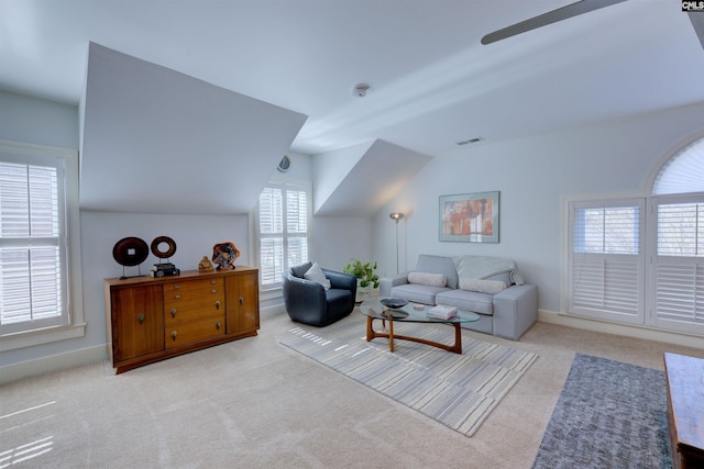 carpeted living room featuring vaulted ceiling