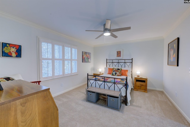 carpeted bedroom with ornamental molding and ceiling fan