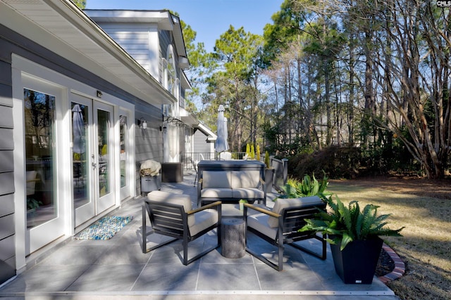 view of patio with a hot tub, an outdoor hangout area, and french doors