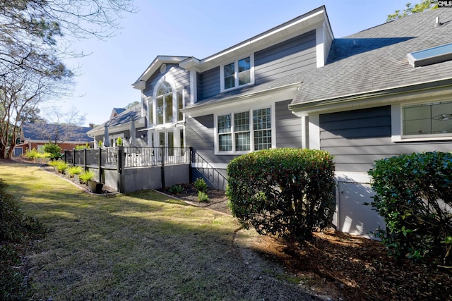 view of home's exterior with a yard