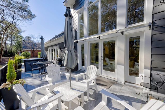 wooden deck with french doors and a patio