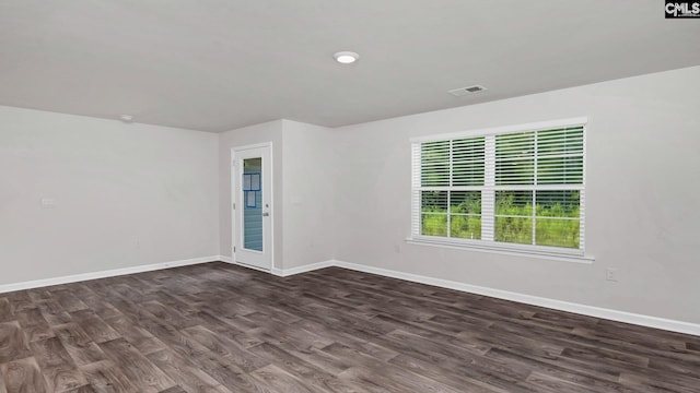 spare room with dark hardwood / wood-style flooring