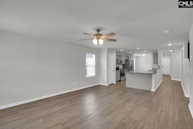 unfurnished living room with ceiling fan and light hardwood / wood-style floors