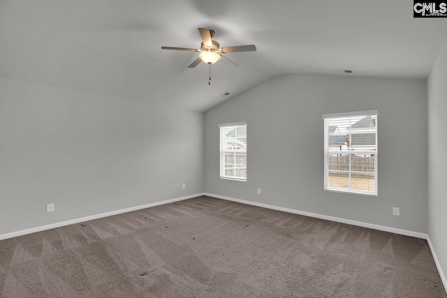 carpeted spare room featuring vaulted ceiling and ceiling fan