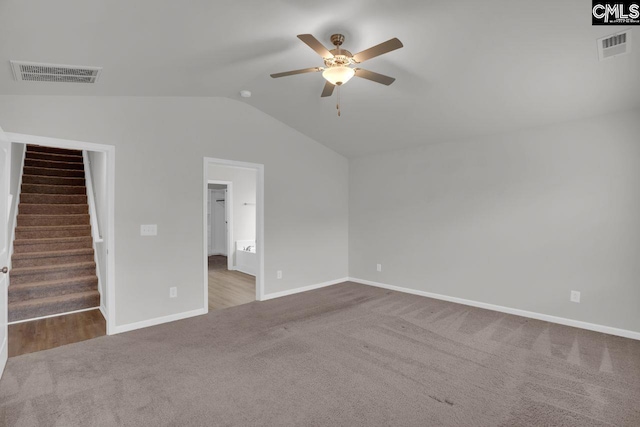 carpeted spare room featuring ceiling fan and vaulted ceiling