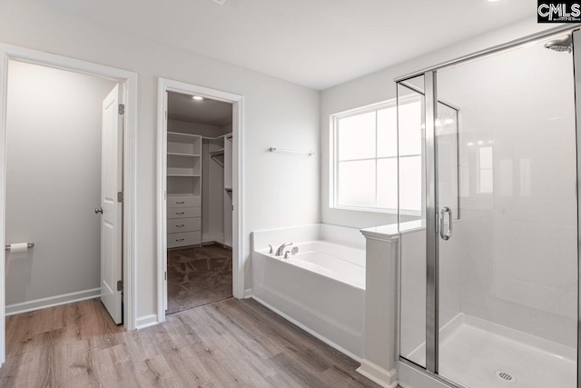 bathroom with hardwood / wood-style floors and plus walk in shower