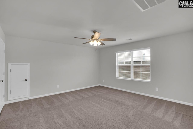 carpeted spare room featuring ceiling fan