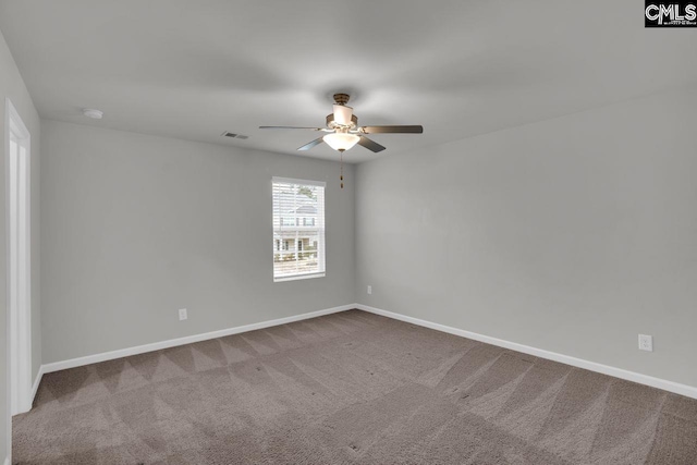 spare room featuring carpet and ceiling fan