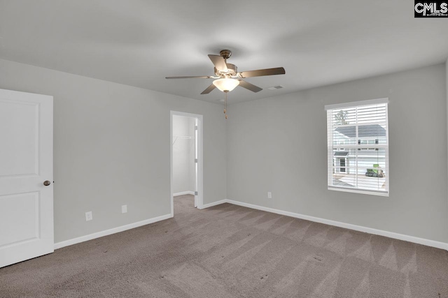 spare room featuring light colored carpet and ceiling fan