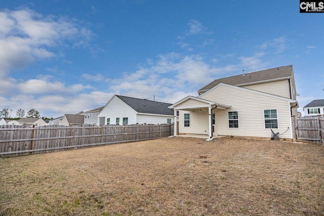 rear view of property with a lawn