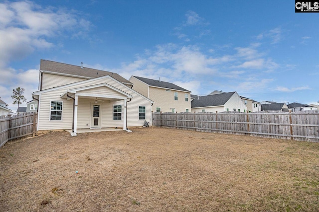 rear view of property with a lawn