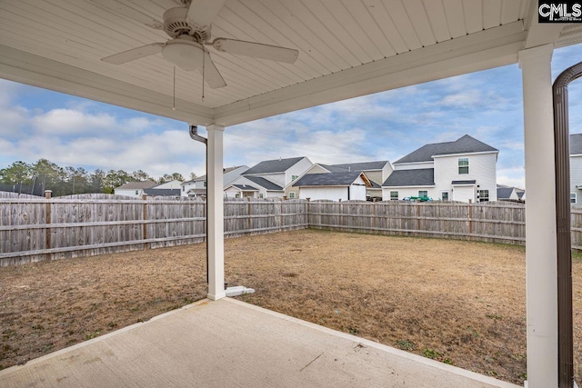 view of yard with ceiling fan and a patio