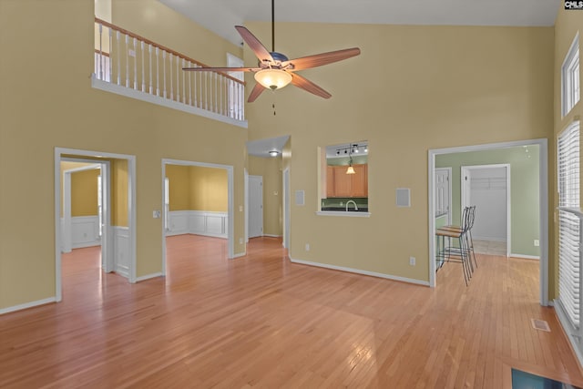 unfurnished living room featuring ceiling fan and light wood-type flooring