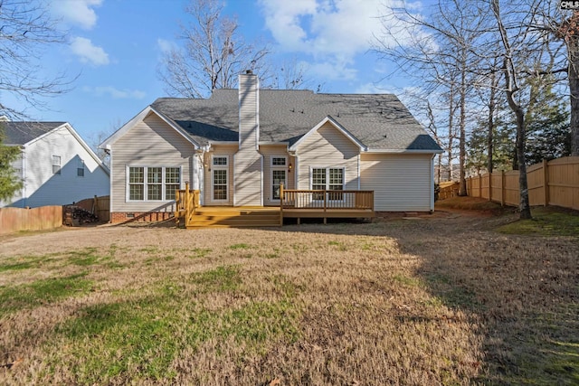 rear view of property with a yard and a deck