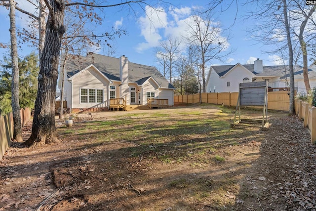 exterior space with a yard, a chimney, crawl space, a fenced backyard, and a wooden deck