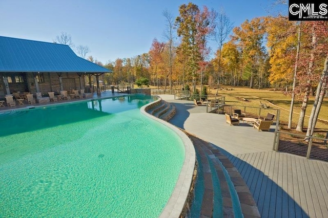 view of swimming pool with a patio area