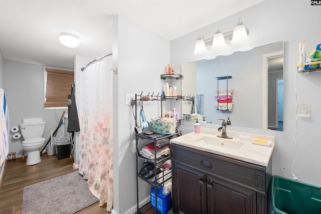 bathroom with vanity, hardwood / wood-style floors, and toilet