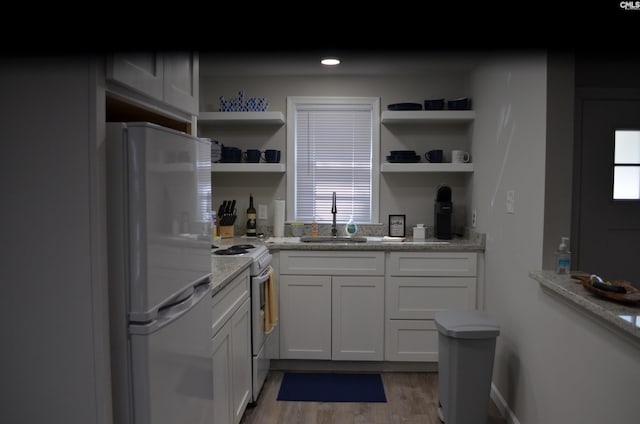 kitchen featuring sink, white appliances, dark wood-type flooring, light stone counters, and white cabinets